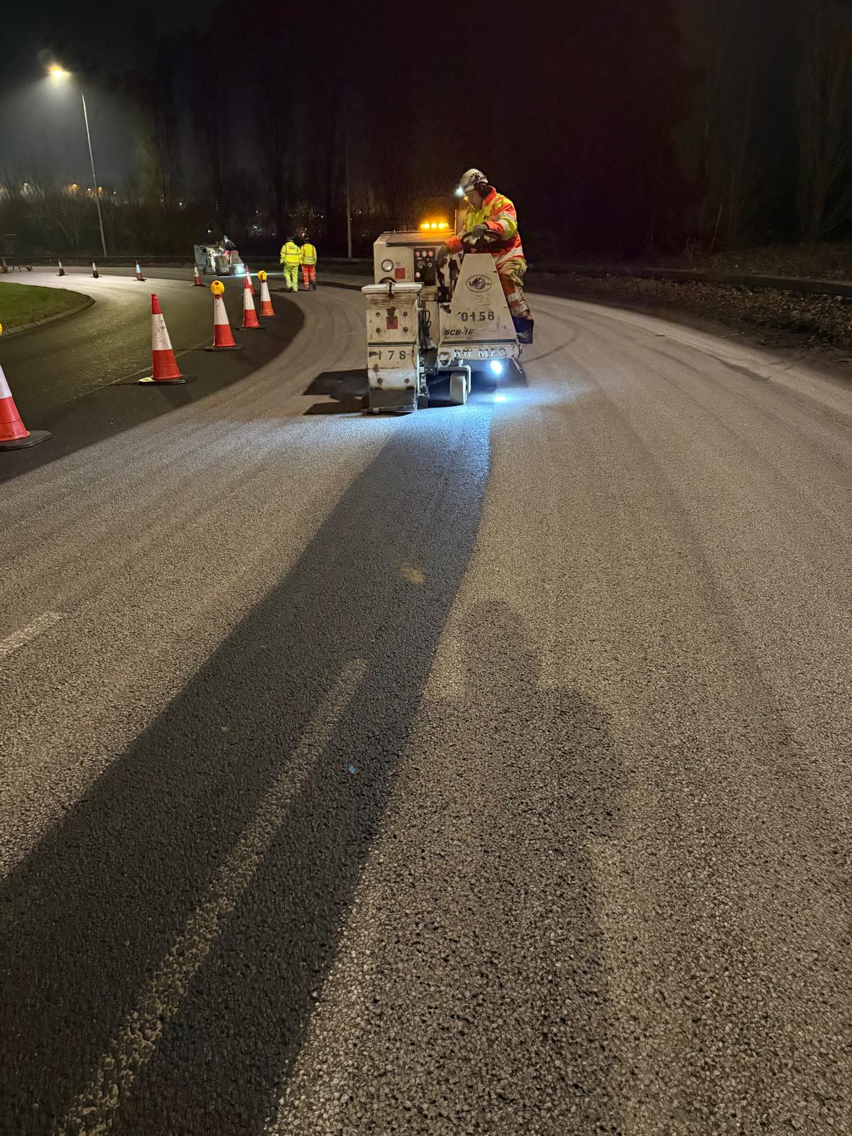 Road being resurfaced by worker